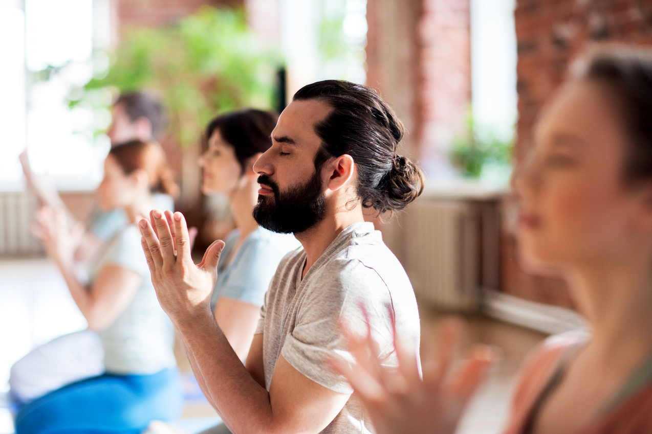 Group of People Meditating at Yoga Studio