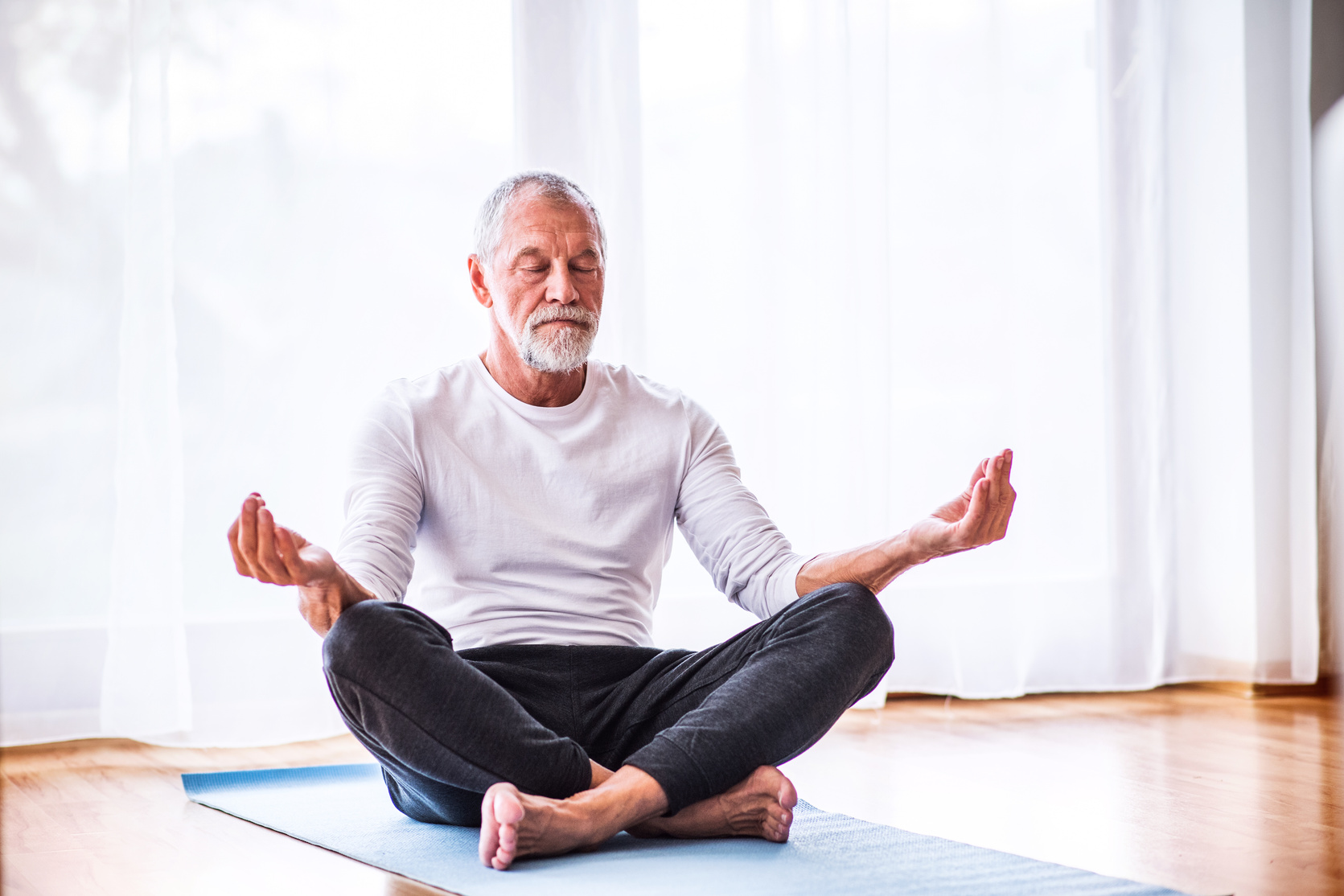 Senior Man Meditating at Home